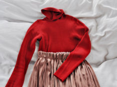 red turtle neck and pleated skirt