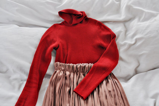 red turtle neck and pleated skirt
